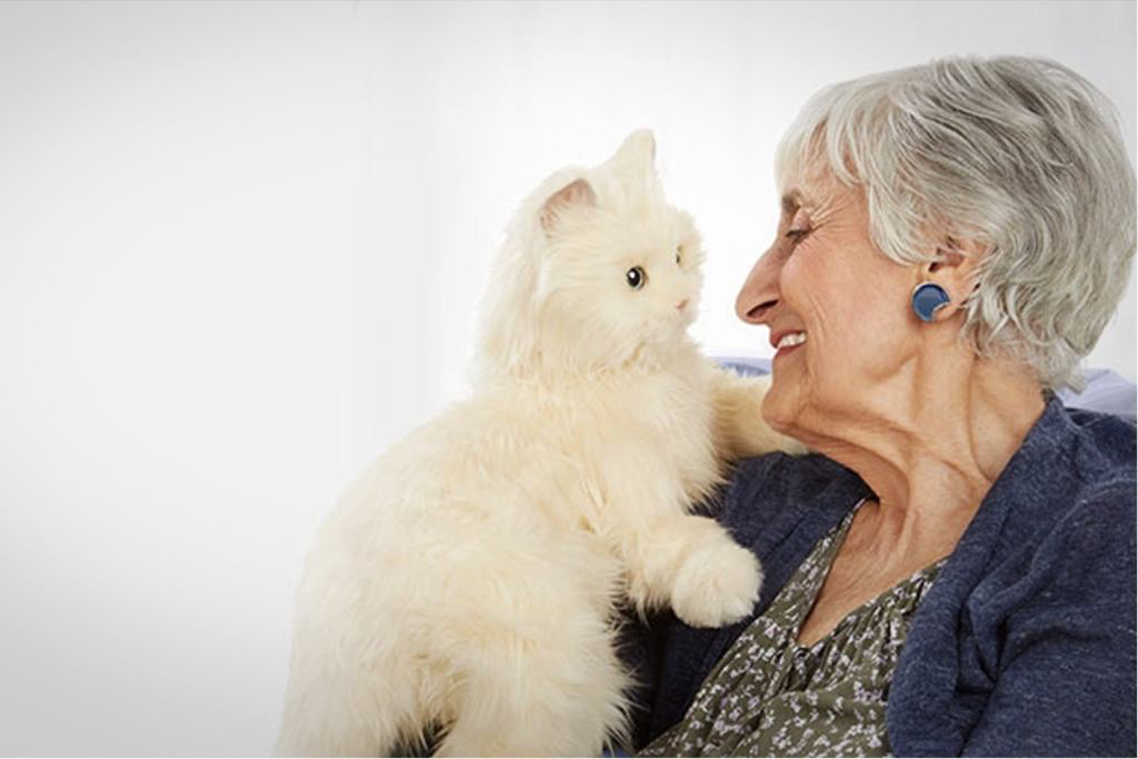 Older adult holding a Joy for All Companion Pet cat